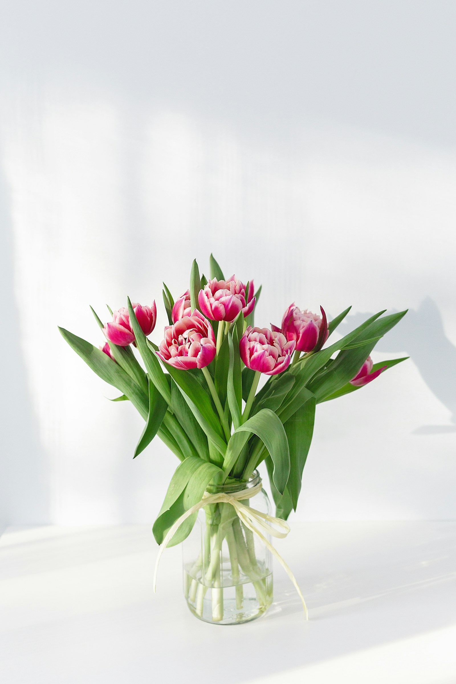 Opulent lush floral centerpiece with rare peonies and wild foliage on a banquet table